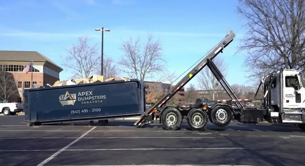 Dumpster delivered via roll-off truck parking lot