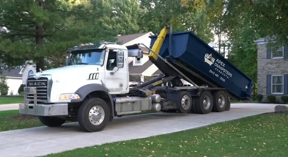 Mack truck delivering Apex Dumpsters container